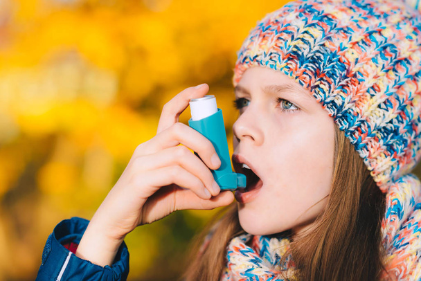 Asthma patient girl inhaling medication for treating shortness o - Photo, Image