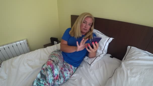 Mujer acostada en la cama y usando smartphone
 - Metraje, vídeo