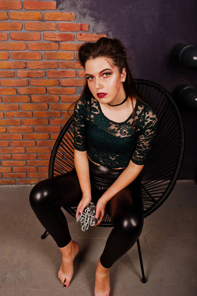 Black girl in green shirt and leather pants with bright make-up  - Φωτογραφία, εικόνα