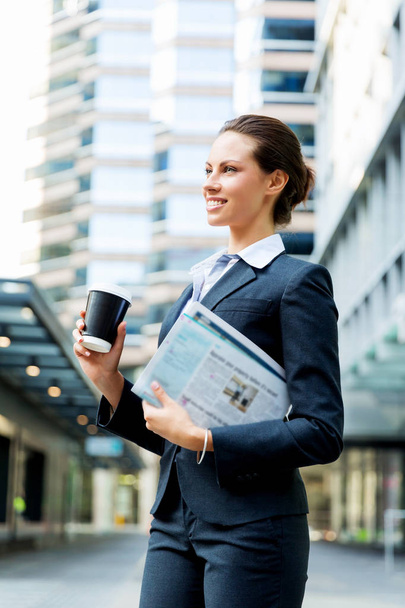 Portrait of business woman walking and smiling outdoor - Foto, Bild