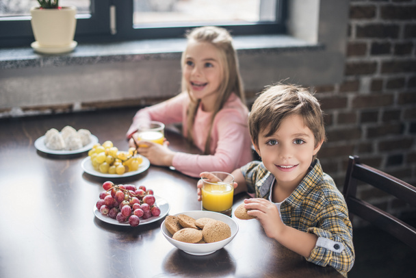 siblings having breakfast at home - Photo, Image