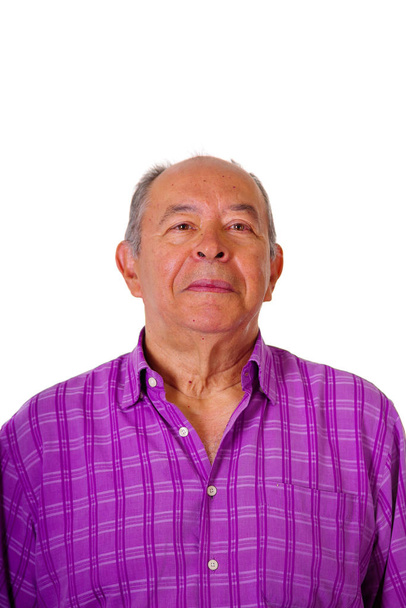 Portrait of a happy mature man wearing a purple square t-shirt in a white background - Foto, Bild
