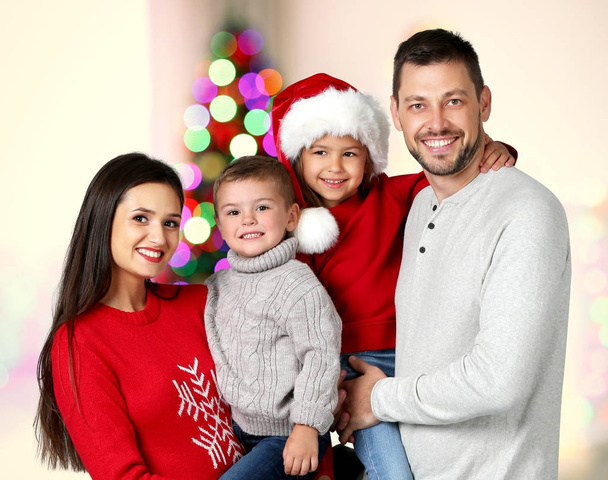 Happy family in room decorated for Christmas celebration - Photo, Image