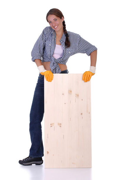 Woman carpenter holding wooden plank - Фото, изображение