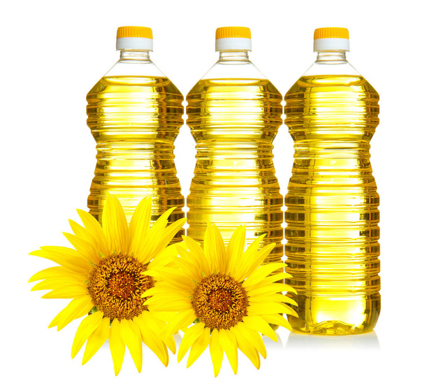 Bottles of cooking oil with sunflowers  - Fotó, kép