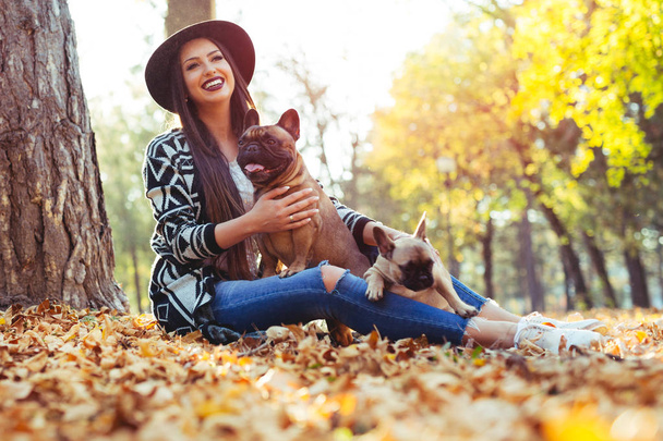 Beautiful woman and his dog in autumn park - Fotoğraf, Görsel