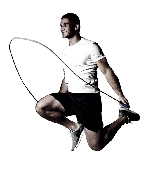 Young man with jumping rope on white background - Foto, afbeelding
