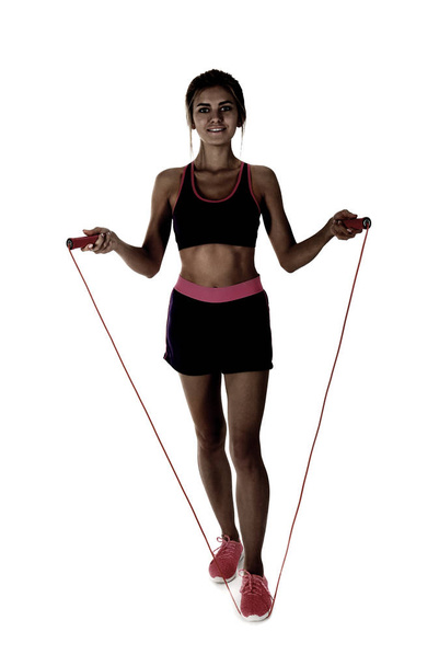 Young woman with jumping rope on white background - Foto, Bild