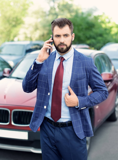 Handsome successful businessman talking on mobile phone outdoors - Fotografie, Obrázek