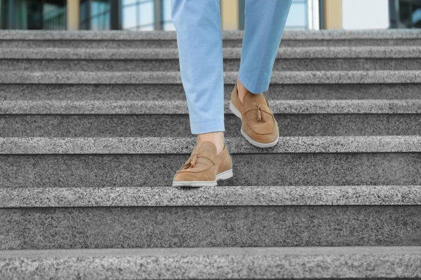 Legs of successful businessman walking down stairs outdoors - Фото, зображення