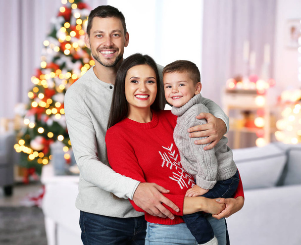 Happy family in room decorated for Christmas celebration - Valokuva, kuva