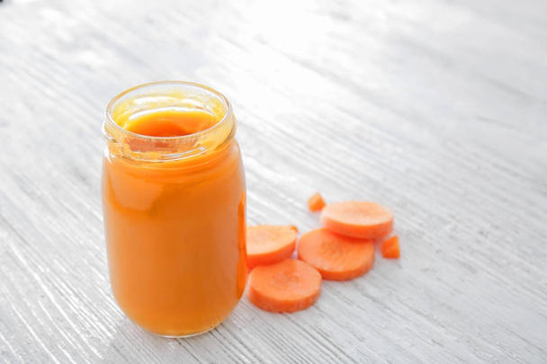 Jar with tasty baby food on wooden table - Foto, Imagem