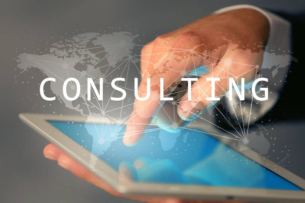 Man working with tablet on blurred background. Consulting service concept - Foto, imagen
