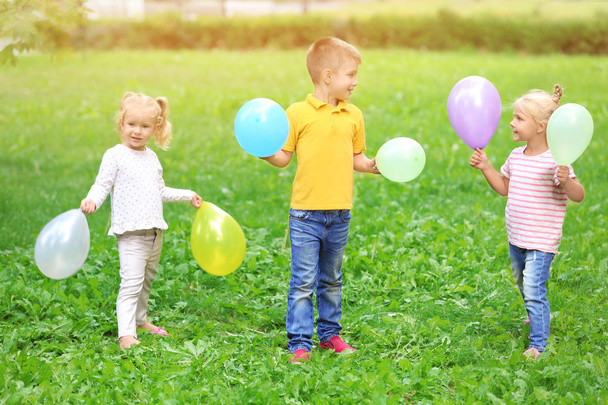 Cute little children playing in green park - Фото, изображение