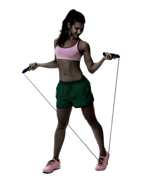 Young woman with jumping rope on white background - 写真・画像