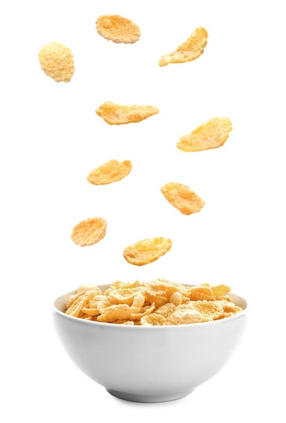 Corn flakes falling into bowl - Photo, image