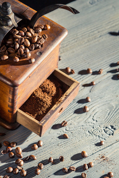 Old fashioned coffee grinder and coffee beans - Photo, Image