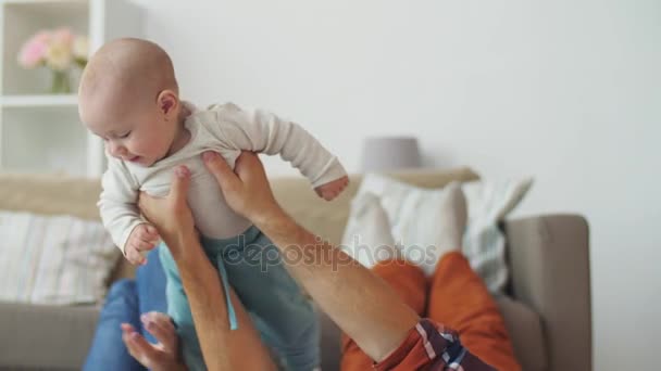 happy mother and father playing with baby at home - Video, Çekim