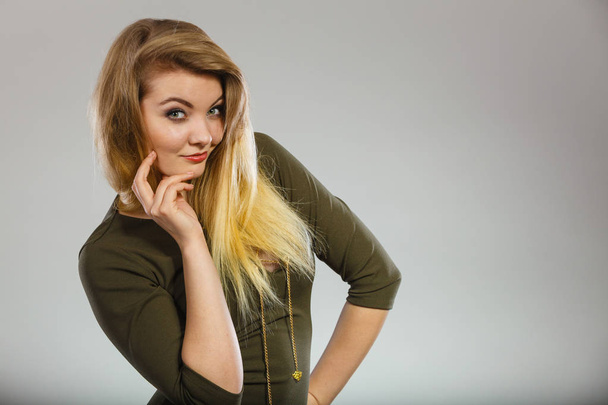 Attractive blonde woman wearing tight green khaki top - Photo, Image