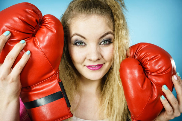 Funny girl with red gloves playing sports boxing - Foto, afbeelding