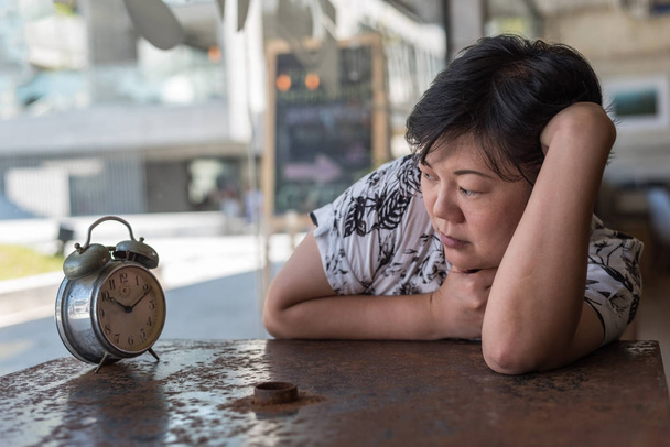 Asian women sleep in coffee shop cafe with clock - Foto, imagen