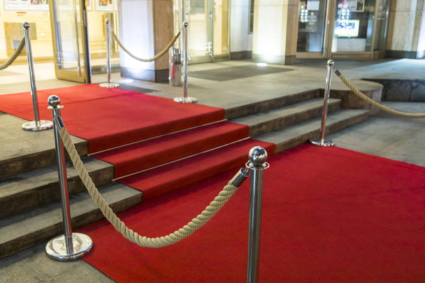 Long red carpet between rope barriers on VIP entrance. - Photo, Image