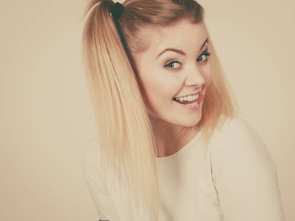 Happy blonde teenager girl with ponytails - Fotó, kép