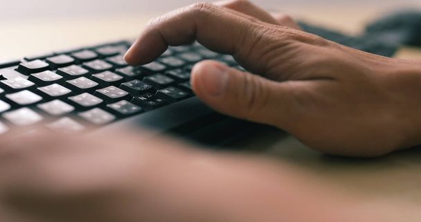 Man hands typing on a computer keyboard  - Fotó, kép