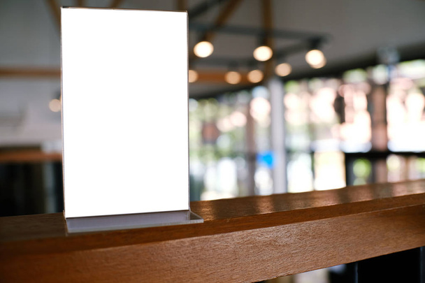 Mock up Menu frame standing on wood table in Bar restaurant cafe. space for text - Photo, Image