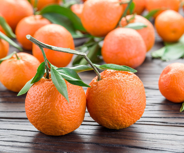 Ripe tangerines on wooden table.  - 写真・画像