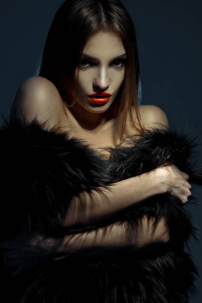 young gorgeous girl with red lips in fur coat looking at the camera - Φωτογραφία, εικόνα