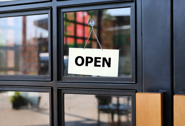 Open sign board hanging on door of cafe. - Photo, image