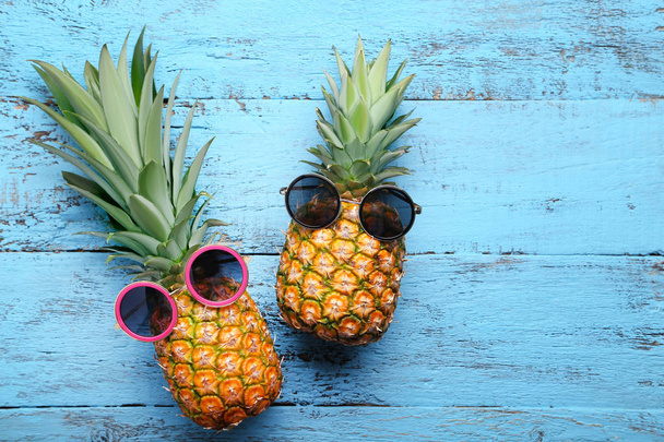 Ripe pineapples with sunglasses  - Photo, image