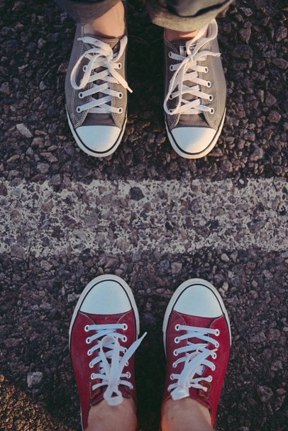sneakers on the road. road. red sneakers on asphalt, top view.   - Photo, Image