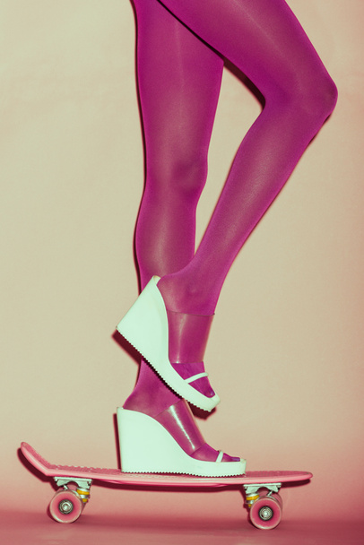 girl in heels on penny board - Foto, Bild