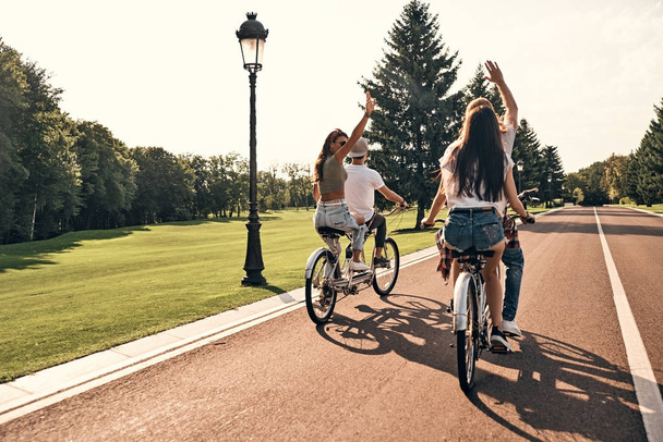 friends riding tandem bicycles - 写真・画像