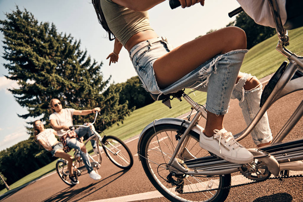 friends enjoying riding tandem bicycles - 写真・画像