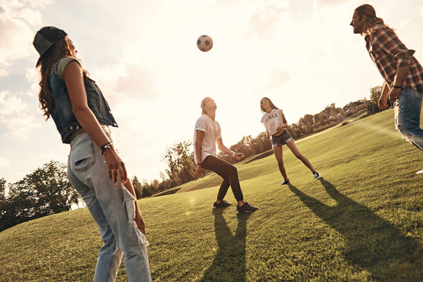four friends playing soccer - Foto, afbeelding