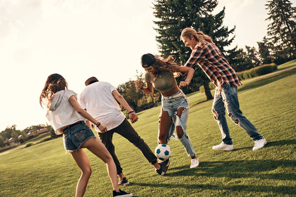 four friends playing soccer - Фото, изображение
