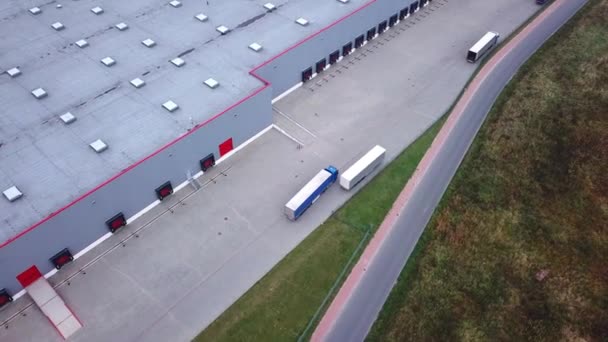 Truck is Driving to Logistics Center. Aerial Shot./ Storage Building/ Loading Area where Many Trucks Are Loading/ Unloading Merchandise - Footage, Video