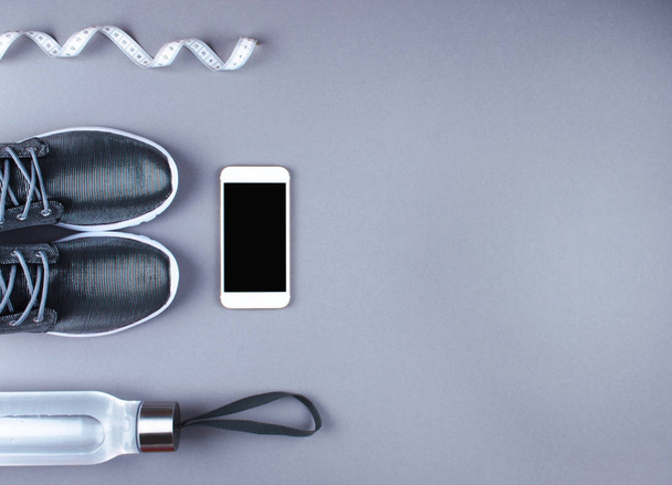 Flat lay shot of sneakers, earphones, phone. - Фото, зображення