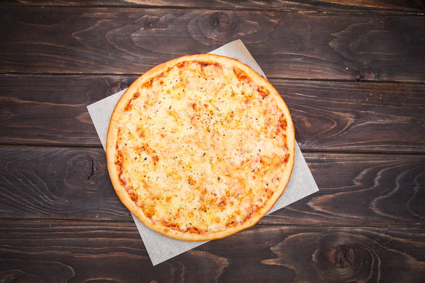tasty traditional pizza on wooden background - Foto, imagen