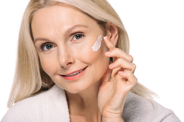 mature woman applying cosmetic cream - Valokuva, kuva