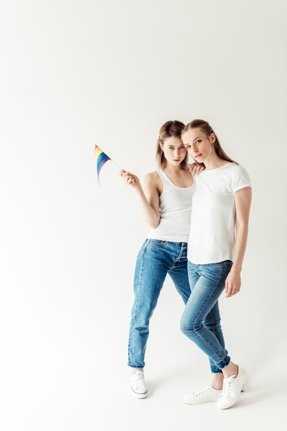 Lesbian couple with small rainbow flag - Fotoğraf, Görsel