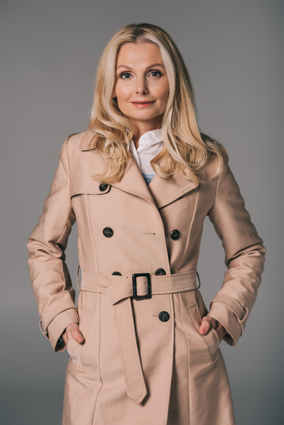 mature woman in trench coat - Фото, зображення