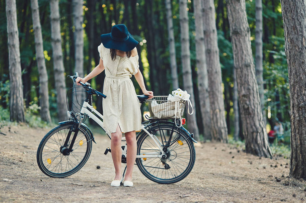 Young woman against nature background with bike - Valokuva, kuva