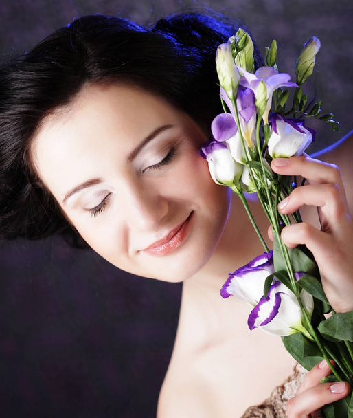 beautiful brunette woman with lilac flowers - Фото, изображение