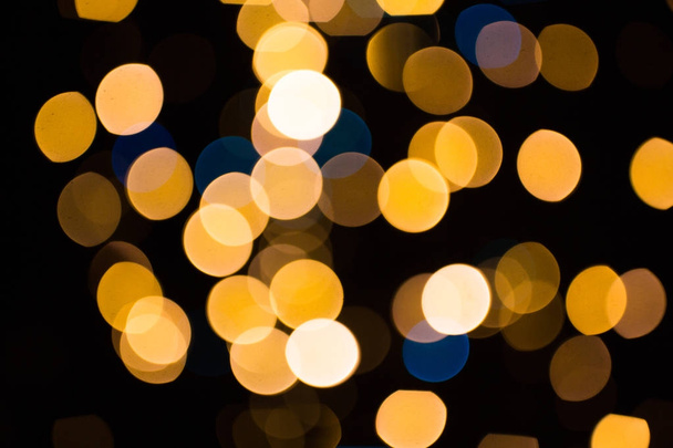 blurred golden lights over dark background - Foto, imagen