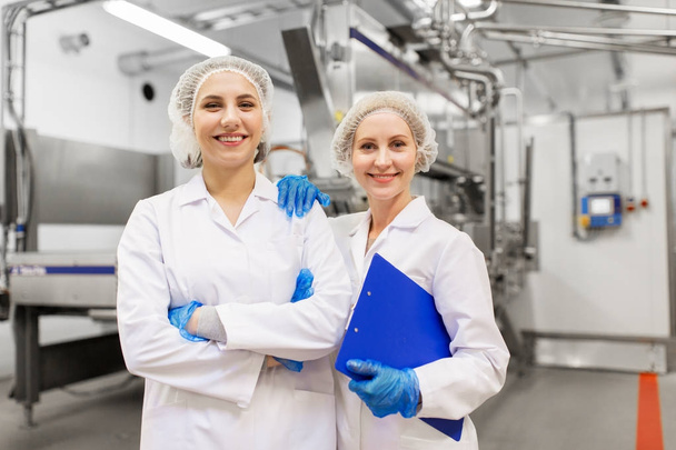 happy women technologists at ice cream factory - Фото, изображение