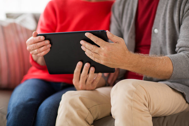 close up of senior couple with tablet pc at home - Photo, image